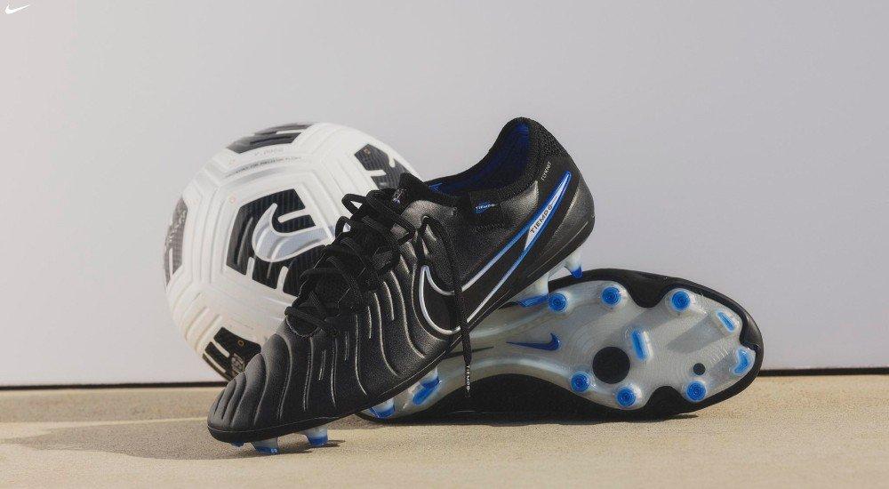 a pair of Nike soccer cleats and a soccer ball