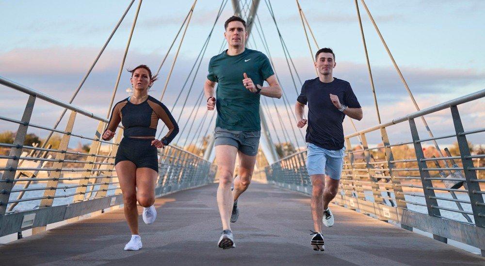 a group of our scheels experts running over a bridge