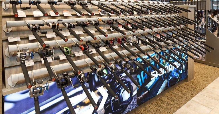 fishing rods and reels display at a SCHEELS store location