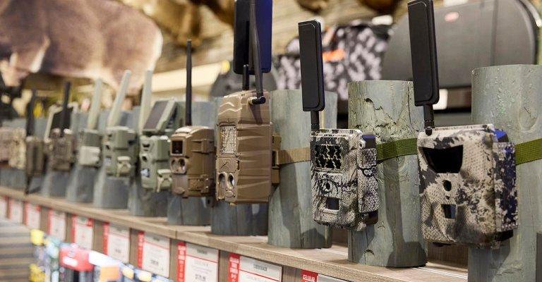 a variety of trail cameras on display at a SCHEELS location