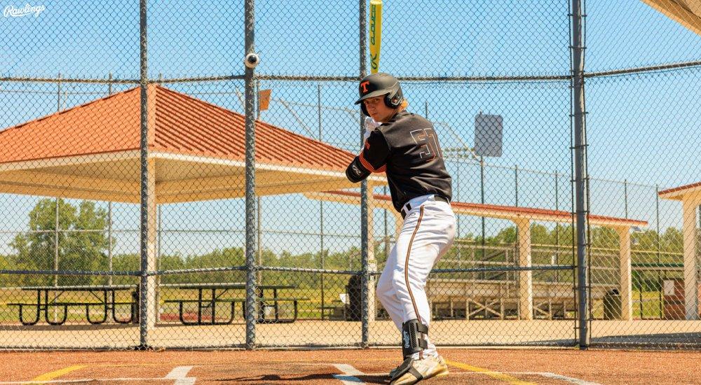 a baseball player using a rawlings bat the the plate
