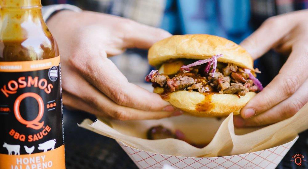 a man holding a brisket sandwich