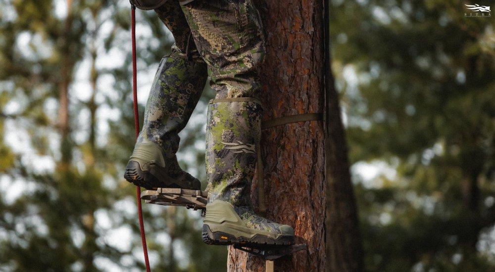 a hunter wearing a pair of SITKA hunting boots while climbing a tree