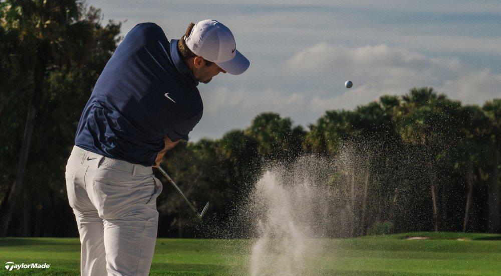 A golfer using a sand wedge