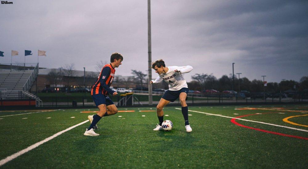 two players on the pitch playing soccer