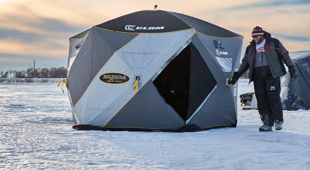 a mother and daughter fishing in a clam ice shelter