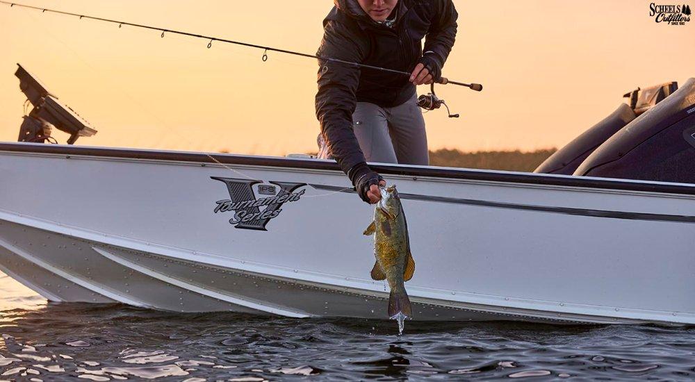 an angler pulling a fish out of the water