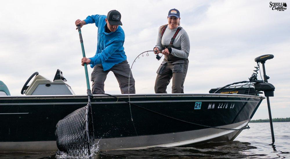 two people fishing on a boat
