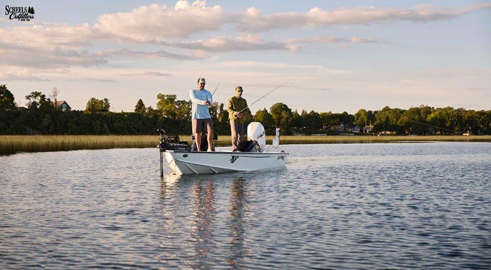 two anglers on a boat during sunset