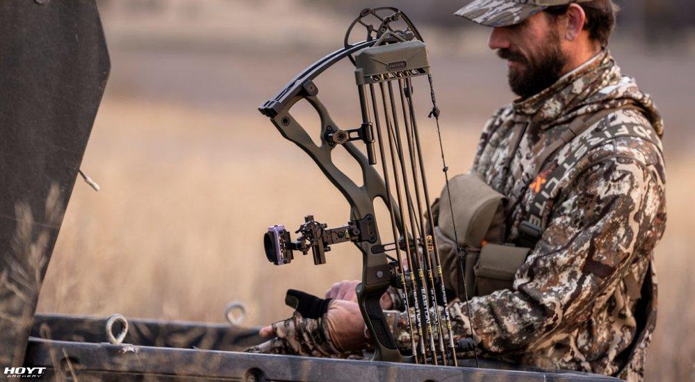 closeup of a hunter holding a compound crossbow