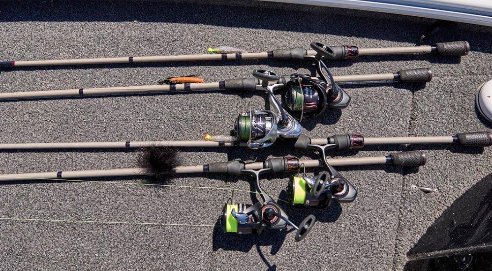 a variety of fishing rods and reel laying on the boat