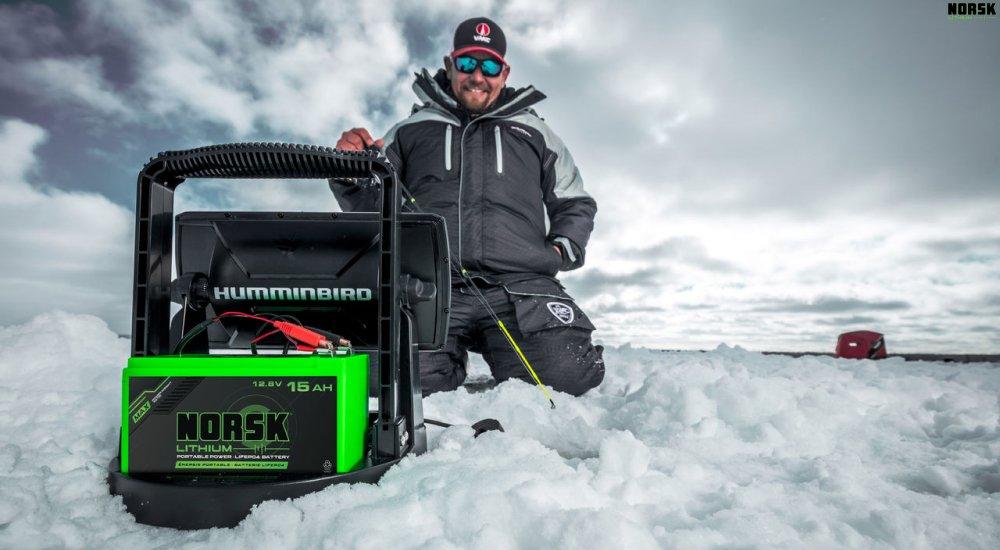 an ice angler using a Norsk battery to power his fish finder