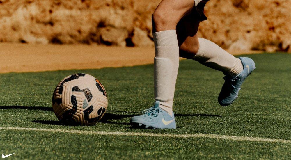 a player kicking a soccer ball at practice while wearing Nike soccer cleats