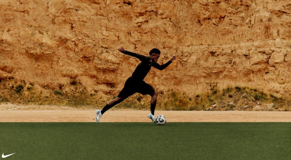 a soccer player practicing in Nike cleats