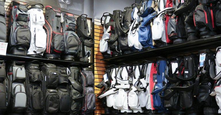 A variety of golf bags and carts on display at SCHEELS.