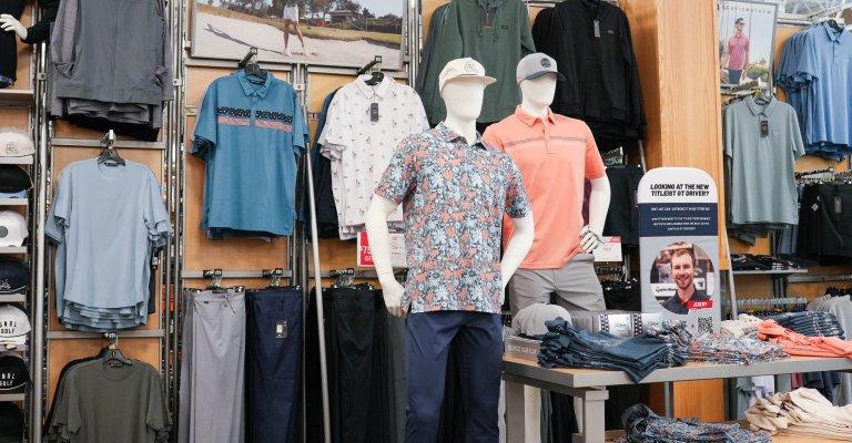 A variety of golf clothing on display at SCHEELS.