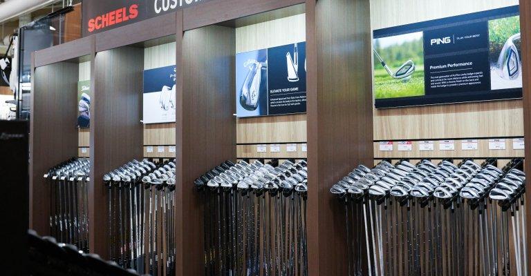 A variety of golf clubs on display at SCHEELS.