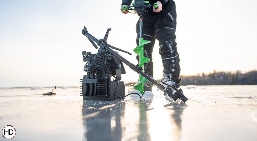 ice fisherman using an auger