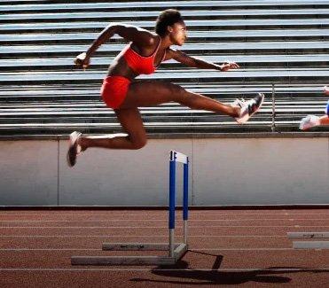 Lifestyle image of hurdler on track