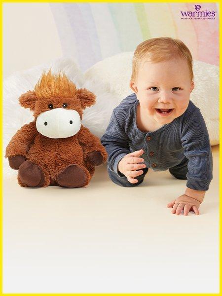 baby with a warmie toy and shop gifts for baby and toddlers