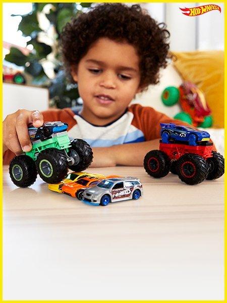 Little boy playing with hot wheels Shop boys toys