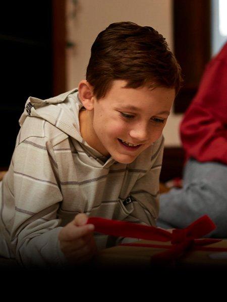Boy opening Christmas present