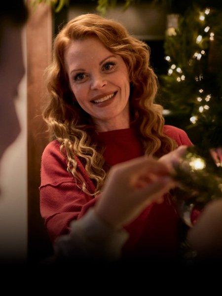 Image of woman decorating Christmas tree