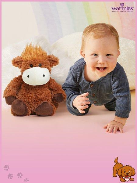 baby with a warmie toy and shop gifts for baby and toddlers