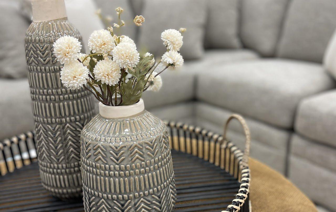 a vase with flowers on a table in a livingroom