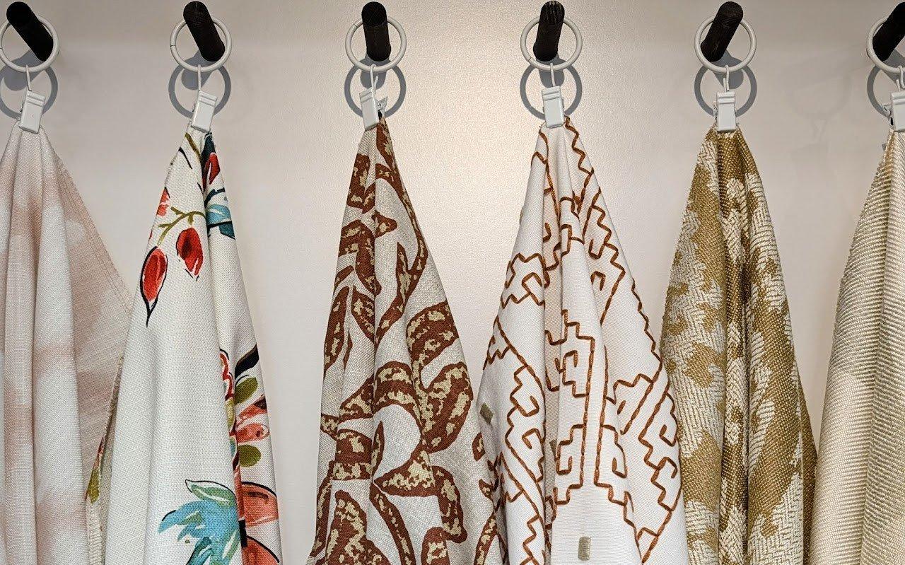 a variety of fabrics with different patterns hanging