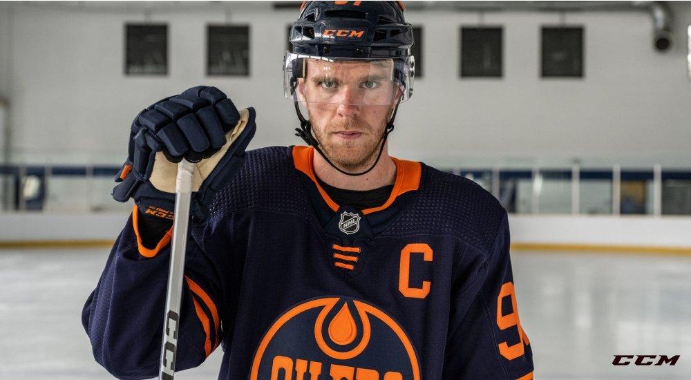 a man with a hockey stick on the ice rink