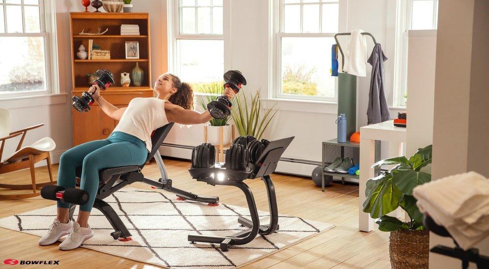 a woman lifting weights in her home gym