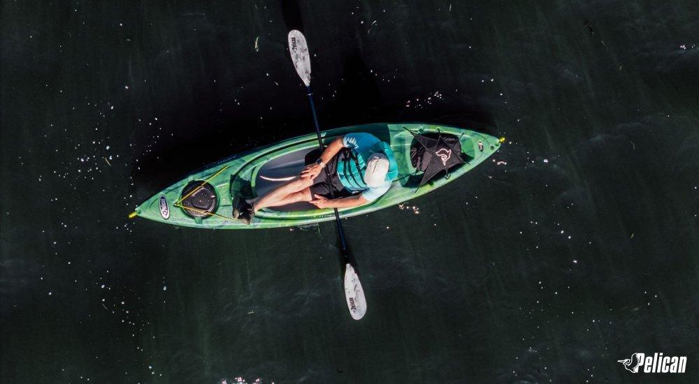 image from above of person sitting in kayak on water