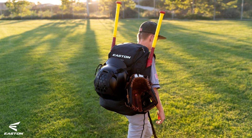 baseball player with an equipment bag walking
