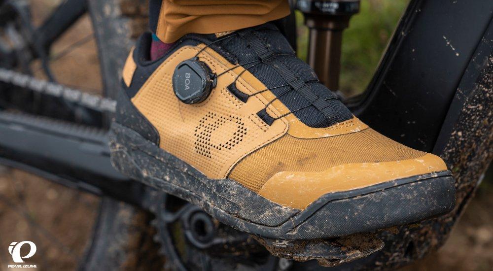 close up image of cycling shoes resting on a bike pedal