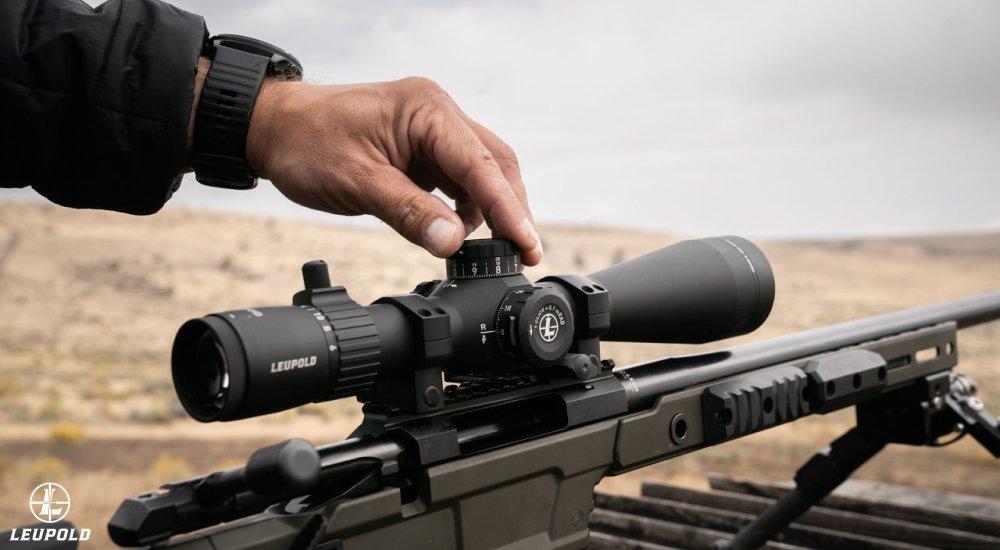 person adjusting the elevation turret on a Leupold riflescope