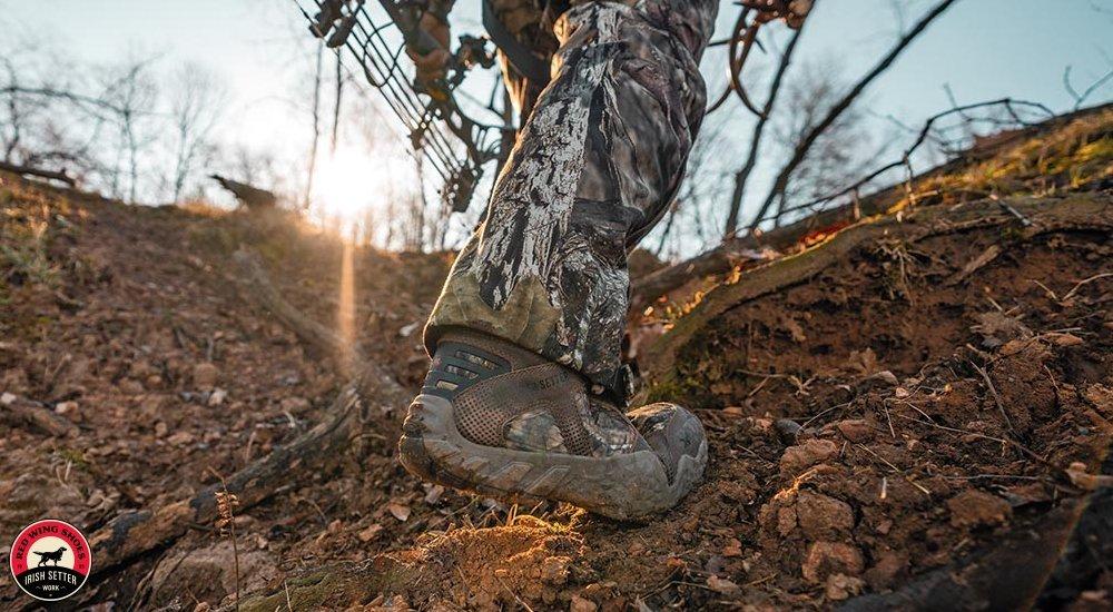 a man stepping through the forest with his Setter Vaprtrek boots