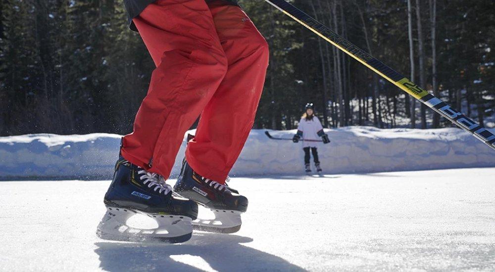 kids skating on the ice playing hockey