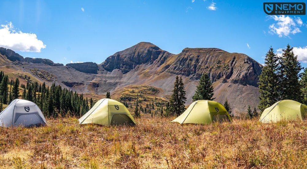 a set of four tents in the mountains