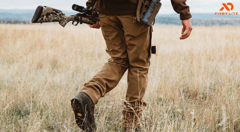 a man walking in a grassland field