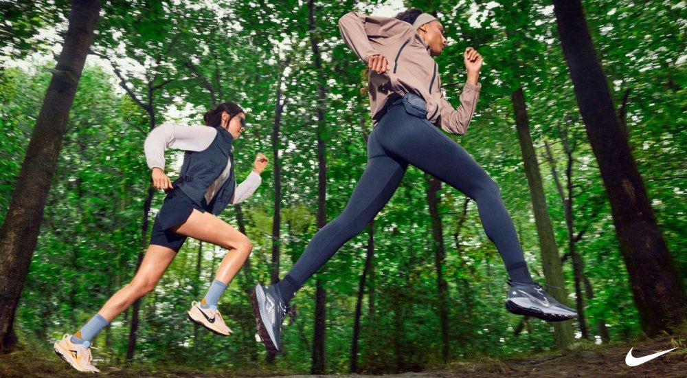 Two women trail running in Nike clothing and shoes