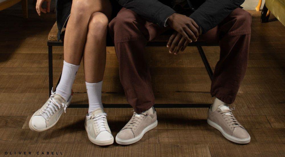 people sitting on a chair wearing sustainable sneakers