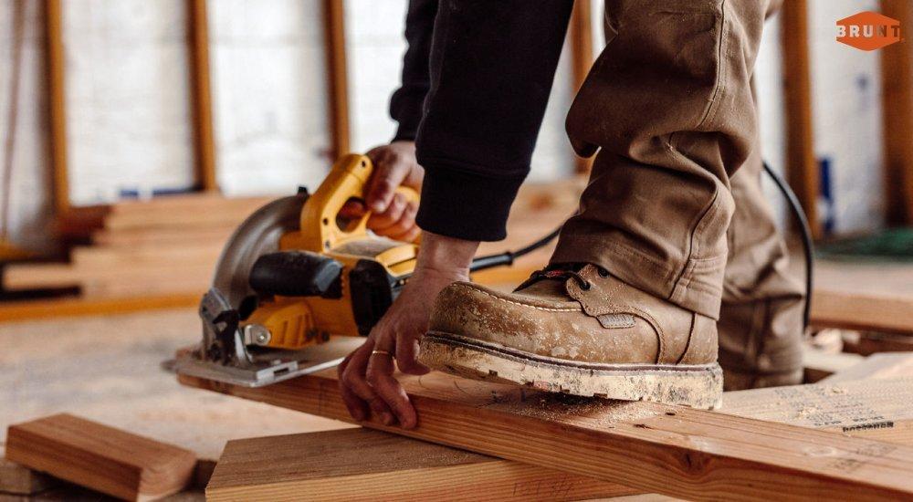A carpenter wears Brunt work boots at the job site