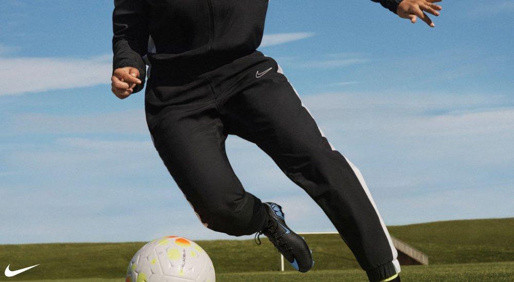 soccer player wearing all black with a soccer ball