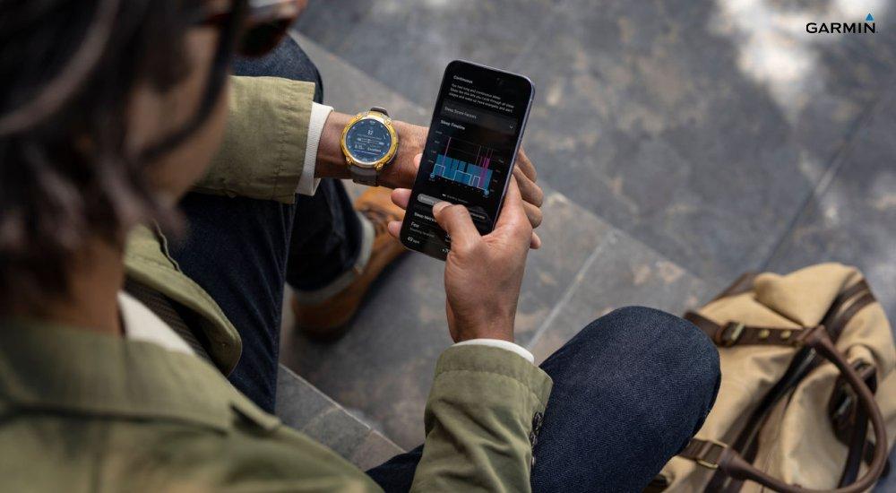 A person looks at their Garmin sleep metrics on their smartphone