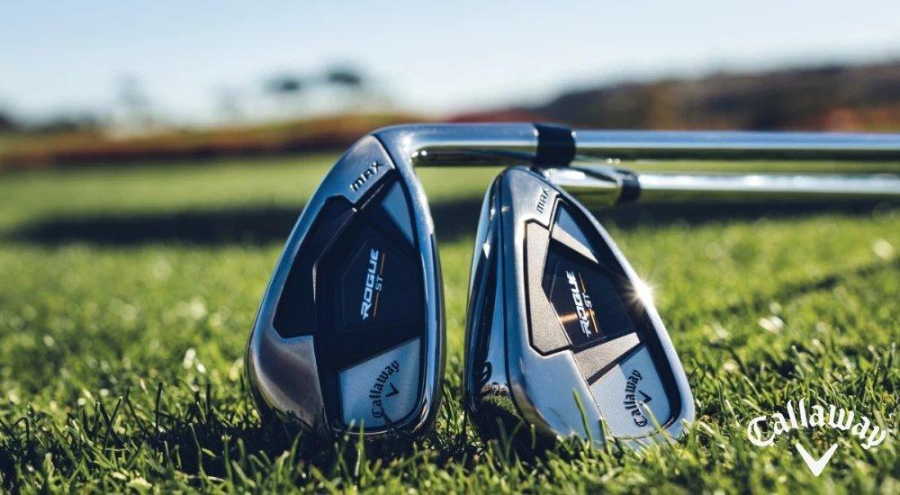 two golf irons laying on the course