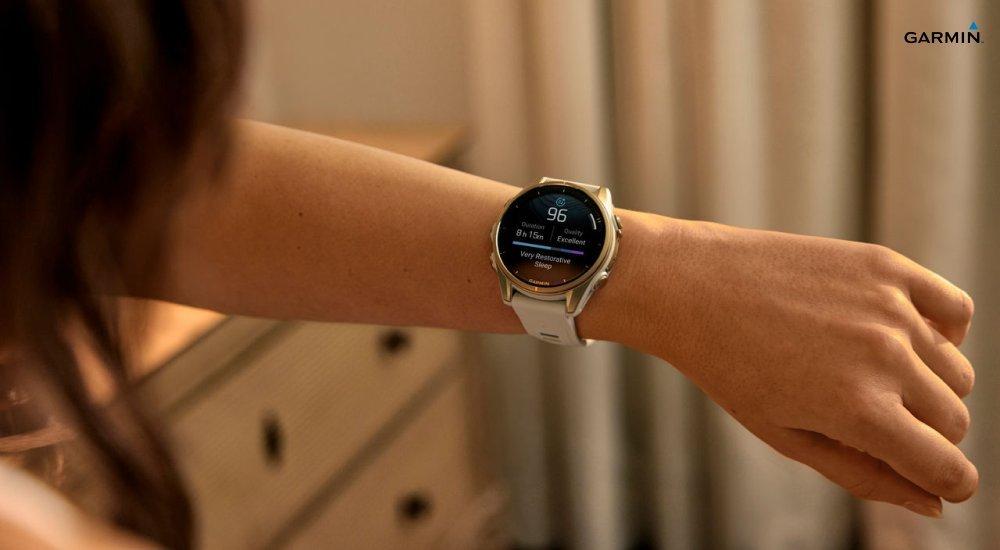 A woman looking at the sleep report on her Garmin smartwatch