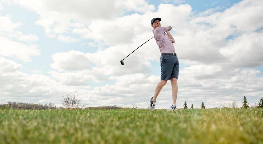 a man swinging a golf club