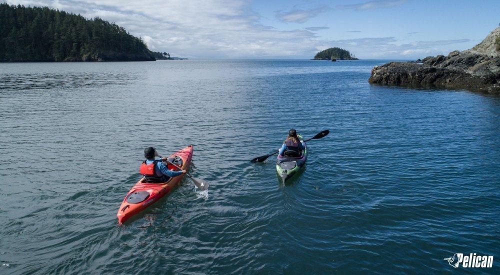 two kayakers paddling on the water