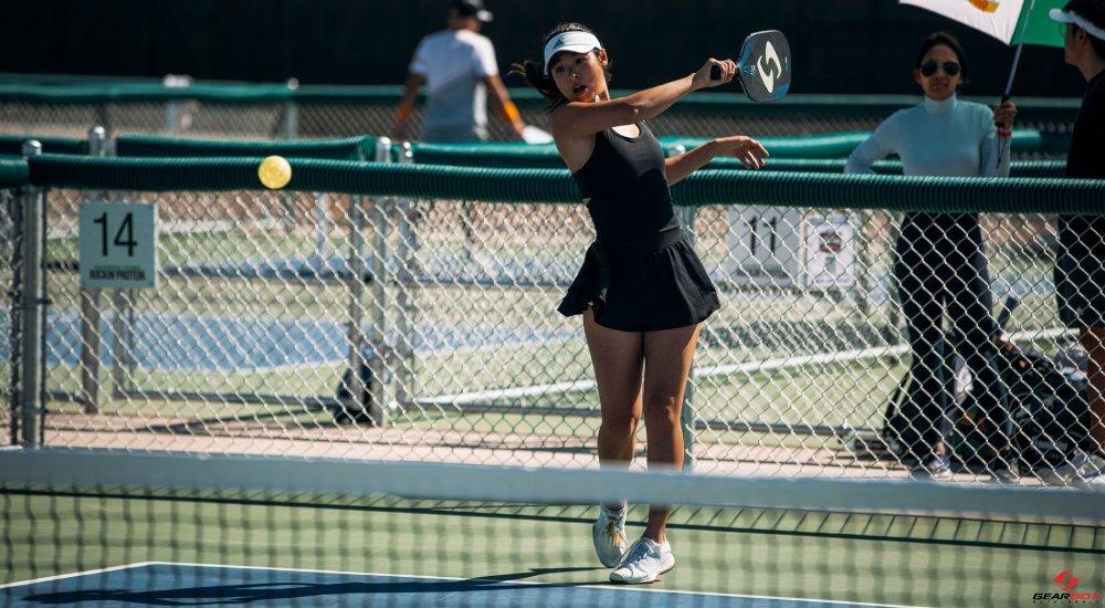 a woman swinging her paddle